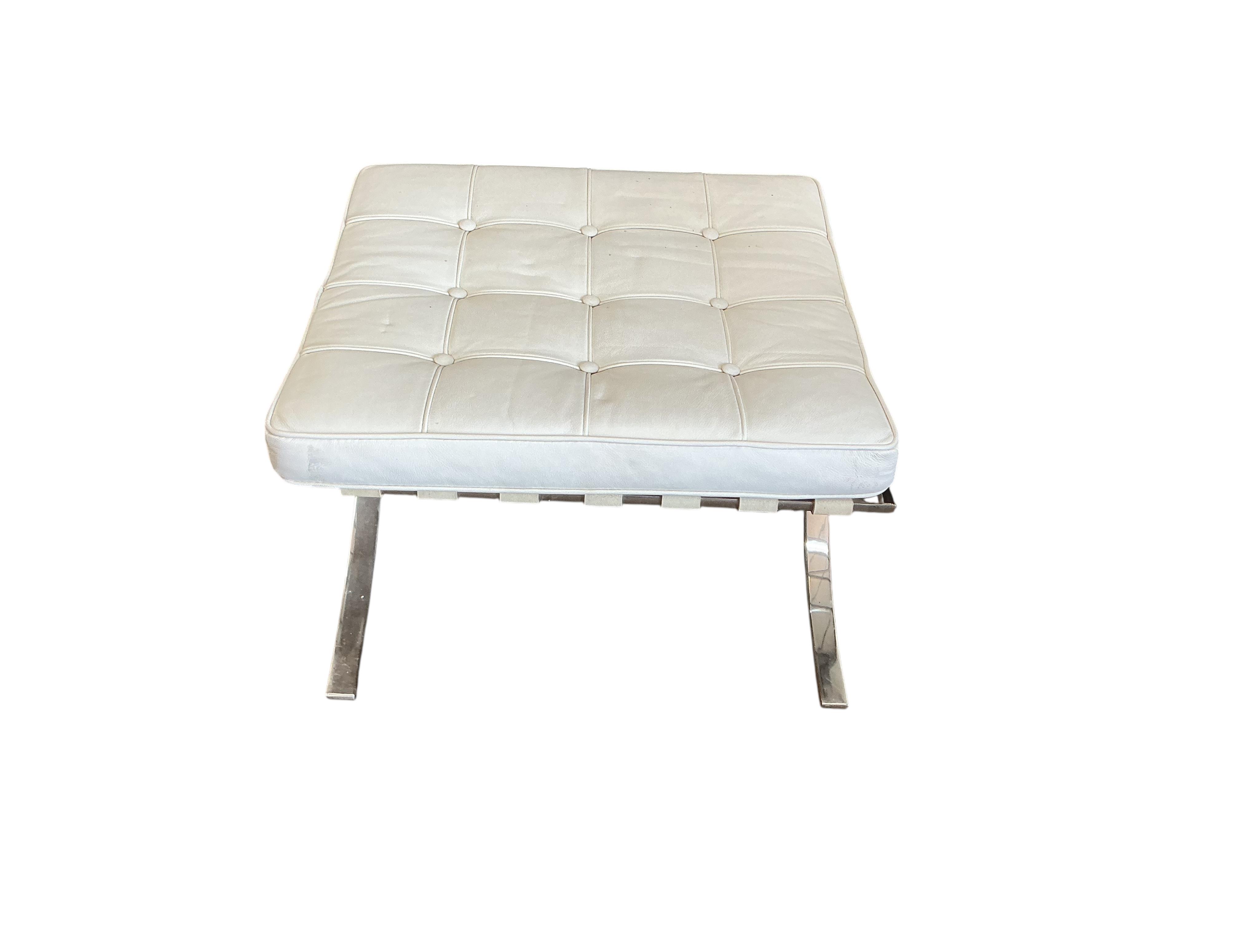 A 'Barcelona style' white leather chair, width 76cm, depth 70cm, height 74cm together with a footstool